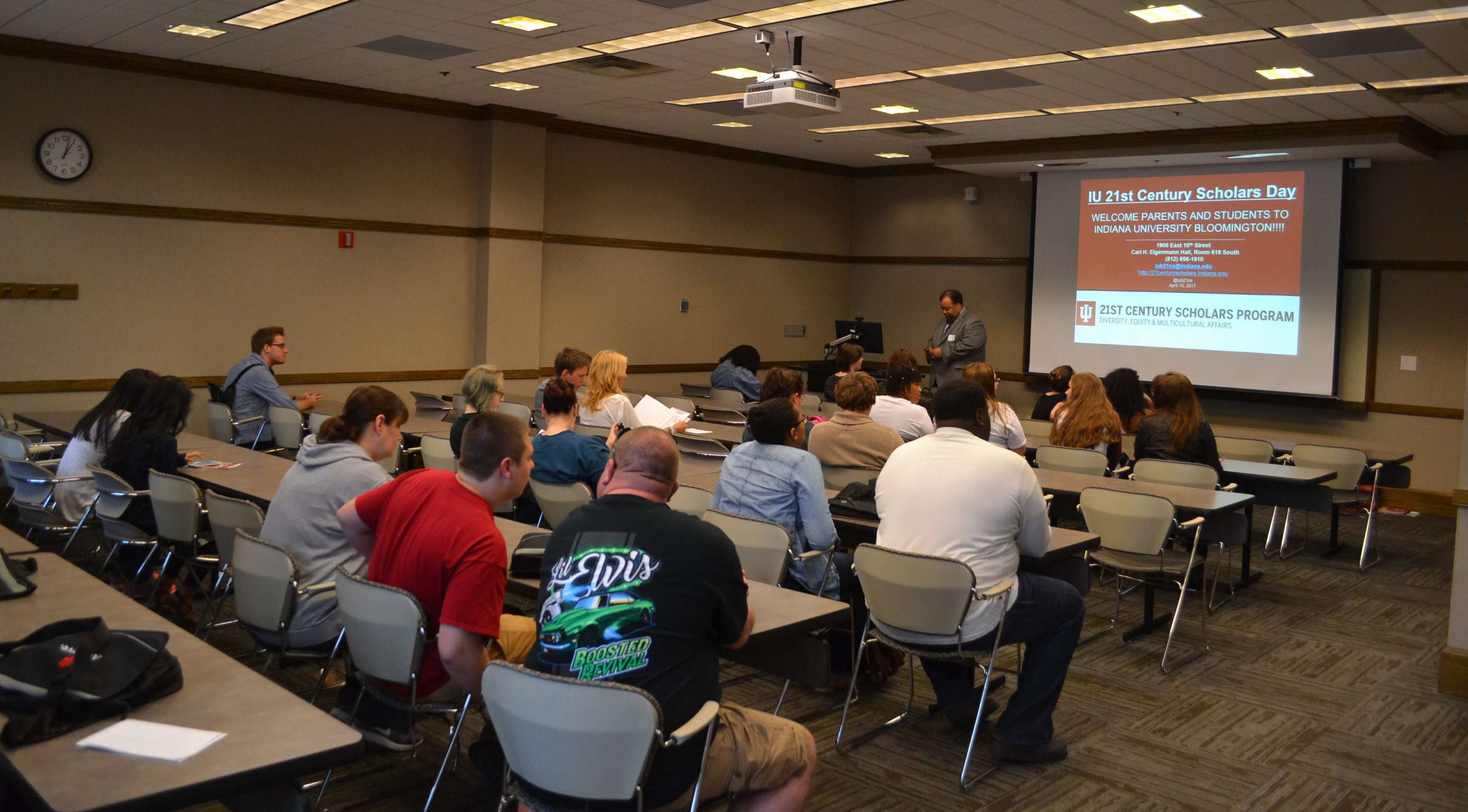 People view a screen in a lecture room