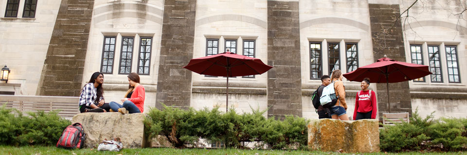 Students lounge and talk outside the IMU building.